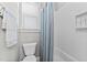Cozy bathroom showcasing a bathtub, shower curtain, tile, and a modern toilet and vanity at 1412 Wakefield Farm Rd, Zebulon, NC 27597
