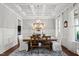 Formal dining room with coffered ceiling, hardwood floors, and elegant lighting at 1412 Wakefield Farm Rd, Zebulon, NC 27597