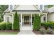 Charming front porch with classic columns and tasteful landscaping at 1412 Wakefield Farm Rd, Zebulon, NC 27597