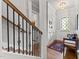 Entryway with staircase, bench seating, hardwood floors, and view into the laundry room at 1412 Wakefield Farm Rd, Zebulon, NC 27597