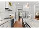 Bright kitchen with stainless appliances, subway tile backsplash, marble countertops, and hardwood floors at 1412 Wakefield Farm Rd, Zebulon, NC 27597