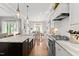 Open concept kitchen with marble counters, stainless appliances and views into the dining area at 1412 Wakefield Farm Rd, Zebulon, NC 27597