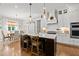 Gourmet kitchen with island, stainless appliances, farmhouse sink, white cabinets, and hardwood floors at 1412 Wakefield Farm Rd, Zebulon, NC 27597