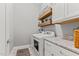 Laundry area with a washer and dryer, granite counters, and white cabinets with shelving at 1412 Wakefield Farm Rd, Zebulon, NC 27597