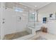 Elegant bathroom featuring a walk-in shower with pebble floor and a classic freestanding tub at 1412 Wakefield Farm Rd, Zebulon, NC 27597