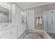 Bathroom featuring double sinks, marble countertops, glass shower, and white cabinets at 1412 Wakefield Farm Rd, Zebulon, NC 27597