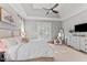 Spacious main bedroom with light gray walls, tray ceiling, and a plush white comforter on the bed at 1412 Wakefield Farm Rd, Zebulon, NC 27597