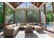 Relaxing sunroom with comfortable seating, a stylish wood ceiling, and views of the backyard pool at 1412 Wakefield Farm Rd, Zebulon, NC 27597