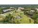 Expansive aerial view of a home on a large lot featuring a private pond, mature trees, and a long driveway at 14393 Nc Hwy 96 N, Zebulon, NC 27597
