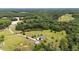 An aerial shot of a house on a spacious green lot, with a pond and mature trees in a beautiful setting at 14393 Nc Hwy 96 N, Zebulon, NC 27597