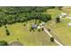 Wide aerial shot displaying a home with a detached garage, a pond, and a lengthy driveway on a well-kept lawn at 14393 Nc Hwy 96 N, Zebulon, NC 27597