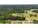 Extensive aerial view reveals a home with a long drive, a pond, and verdant surroundings at 14393 Nc Hwy 96 N, Zebulon, NC 27597