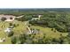 Sweeping aerial view of a home with pond and well-manicured lawn amid lush greenery at 14393 Nc Hwy 96 N, Zebulon, NC 27597