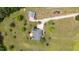 Aerial perspective of a home with a large driveway and detached garage in a lush green surrounding at 14393 Nc Hwy 96 N, Zebulon, NC 27597