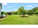 An inviting green lawn with mature trees creates a serene and private backyard setting at 14393 Nc Hwy 96 N, Zebulon, NC 27597