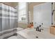 Bathroom features a shower with a striped curtain and single sink vanity at 14393 Nc Hwy 96 N, Zebulon, NC 27597