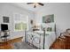 Bright bedroom features a decorative rug, wood floors, and a large window at 14393 Nc Hwy 96 N, Zebulon, NC 27597