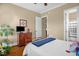 Cozy bedroom features a wood dresser, tv, and view to an ensuite bathroom at 14393 Nc Hwy 96 N, Zebulon, NC 27597