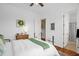 Bright bedroom with wood floors, a decorative rug, and view into an ensuite bathroom at 14393 Nc Hwy 96 N, Zebulon, NC 27597