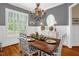 Elegant dining room featuring hardwood floors, wainscoting, chandelier, and abundant natural light at 14393 Nc Hwy 96 N, Zebulon, NC 27597