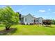 A beautiful view of a well-maintained two-story home with a covered porch and landscaped backyard at 14393 Nc Hwy 96 N, Zebulon, NC 27597