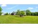 Exterior shot of a beautiful home surrounded by a lush green lawn and mature trees at 14393 Nc Hwy 96 N, Zebulon, NC 27597