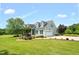 Well-maintained two story home boasts an attached garage and verdant landscaping at 14393 Nc Hwy 96 N, Zebulon, NC 27597