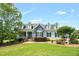 Charming home showcasing landscaped yard, dormer windows, and a welcoming front porch at 14393 Nc Hwy 96 N, Zebulon, NC 27597