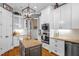Charming kitchen featuring custom white cabinetry, island, stainless steel appliances, and modern lighting at 14393 Nc Hwy 96 N, Zebulon, NC 27597