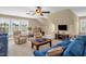 Spacious living room with plush seating, a ceiling fan, and large windows for ample light at 14393 Nc Hwy 96 N, Zebulon, NC 27597
