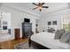Light and airy main bedroom features hardwood floors, a ceiling fan, and ensuite bathroom at 14393 Nc Hwy 96 N, Zebulon, NC 27597