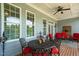 Covered patio with comfortable seating, a ceiling fan, and views of the surrounding yard at 14393 Nc Hwy 96 N, Zebulon, NC 27597