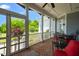 Screened-in patio with brick flooring, outdoor furniture, and a view of the landscaped yard at 14393 Nc Hwy 96 N, Zebulon, NC 27597