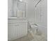 A modern bathroom with white vanity, toilet, and shower with tiled floors at 1466 Salem Creek Dr, Apex, NC 27502