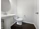 Bathroom featuring a pedestal sink, toilet, and sleek fixtures against a neutral backdrop at 1466 Salem Creek Dr, Apex, NC 27502