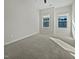 A comfortable bedroom featuring plush carpeting and ample natural light from two windows at 1466 Salem Creek Dr, Apex, NC 27502