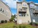 Two-story home featuring a wooden balcony, neutral siding, and a backyard with green grass at 1466 Salem Creek Dr, Apex, NC 27502
