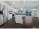 Bright kitchen with white cabinets, stainless steel appliances, a central island, and hardwood flooring at 1466 Salem Creek Dr, Apex, NC 27502