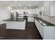 A stylish kitchen features white cabinetry, granite countertops, and stainless steel appliances at 1466 Salem Creek Dr, Apex, NC 27502