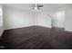 Spacious living room with hardwood floors, a ceiling fan, and a staircase leading to the upper level at 1466 Salem Creek Dr, Apex, NC 27502