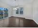 Bright living room with hardwood floors, a large window, and sliding glass doors to a balcony at 1466 Salem Creek Dr, Apex, NC 27502
