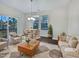 Staged living room with a hardwood floor, natural light, comfortable seating, and a view of the outdoors at 1466 Salem Creek Dr, Apex, NC 27502