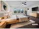 Staged main bedroom with a ceiling fan, hardwood floor, large bed, natural light, and modern decor at 1466 Salem Creek Dr, Apex, NC 27502