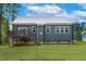 Back view of home with yard and deck at 154 Buckaroo Dr, Louisburg, NC 27549