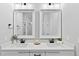 Bright bathroom featuring dual sinks with modern fixtures, quartz countertops, and a view of the walk-in shower at 154 Buckaroo Dr, Louisburg, NC 27549