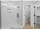 Luxurious bathroom with marble-look tile shower and glass door and an adjacent toilet room and closet at 154 Buckaroo Dr, Louisburg, NC 27549