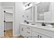 Elegant bathroom with double vanities, quartz countertops, modern fixtures, and a walk-in closet at 154 Buckaroo Dr, Louisburg, NC 27549