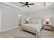 Relaxing bedroom boasts tray ceilings, neutral palette, and an ensuite bathroom for added convenience at 154 Buckaroo Dr, Louisburg, NC 27549