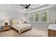Serene bedroom with large windows, a tray ceiling, neutral colors, and plush carpeting at 154 Buckaroo Dr, Louisburg, NC 27549