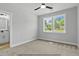 Inviting bedroom with a ceiling fan and bright windows overlooking a peaceful street at 154 Buckaroo Dr, Louisburg, NC 27549